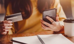 Woman holding debit card on phone