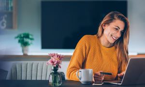 Woman smiling holding credit card