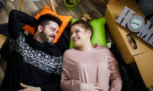 Couple laying on floor in new home