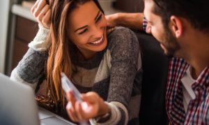 Woman smiling holding debit card