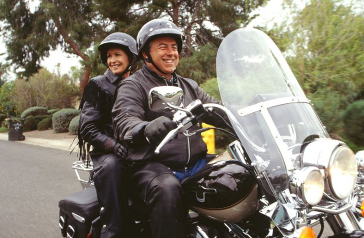 image of man and woman on a motorcycle